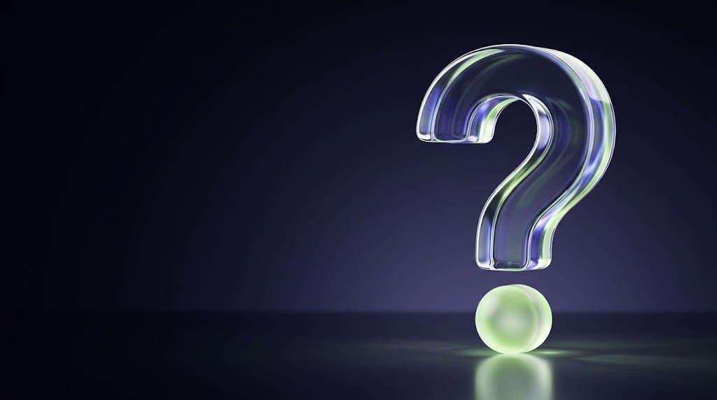 Glass question mark with a glowing green sphere as its dot, symbolizing the questions clients ask before starting a project